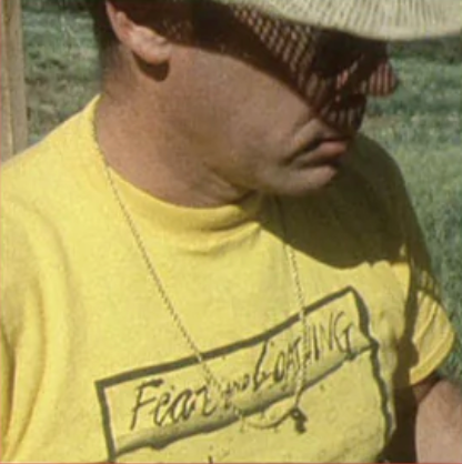 a man wearing a yellow shirt and a hat