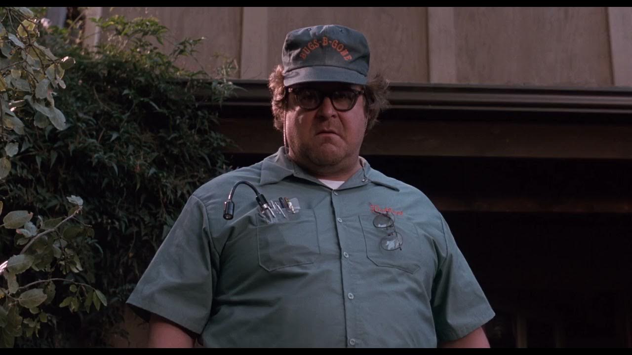 a man wearing a green shirt and a hat