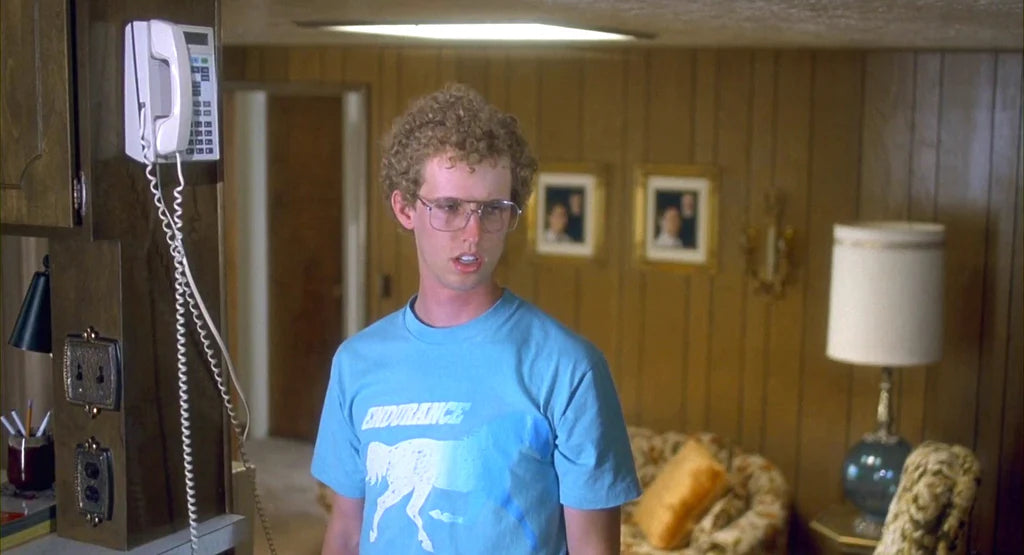 a man in a blue shirt standing in a living room