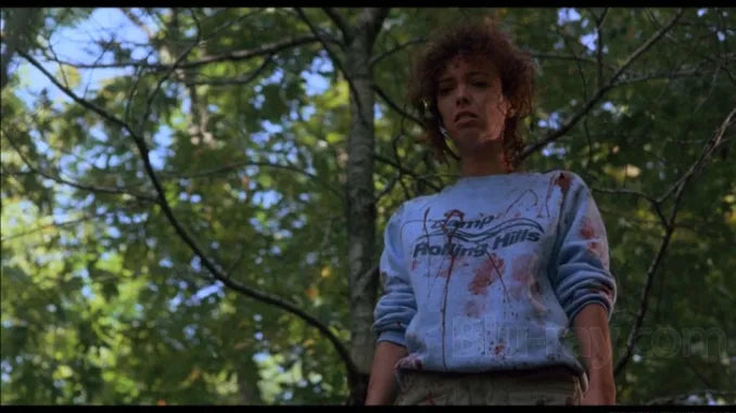 a woman standing in front of a tree