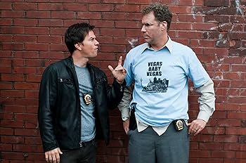 a couple of men standing next to a brick wall