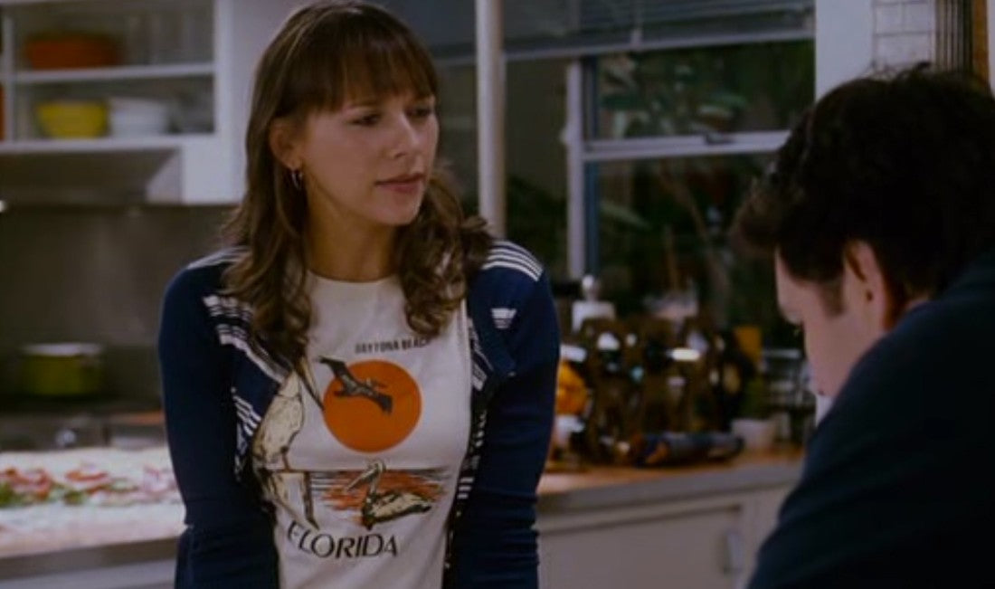 a woman standing in a kitchen next to a man