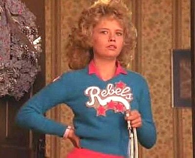 Samantha from Night of the Comet wearing the Rebels cheerleading uniform in blue and red.