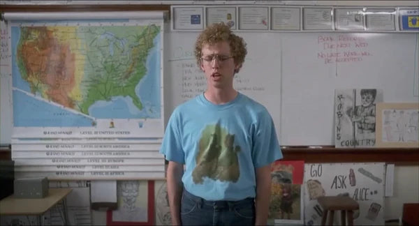 a young man standing in front of a map of the united states