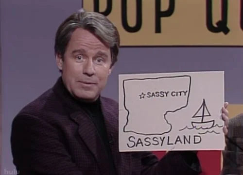 a man holding a sign that says sassy city