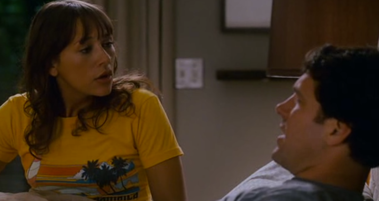 a man sitting next to a woman in a kitchen