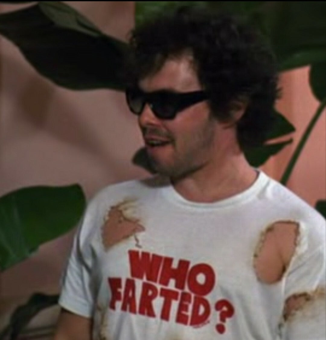 a man wearing a white shirt with holes in it