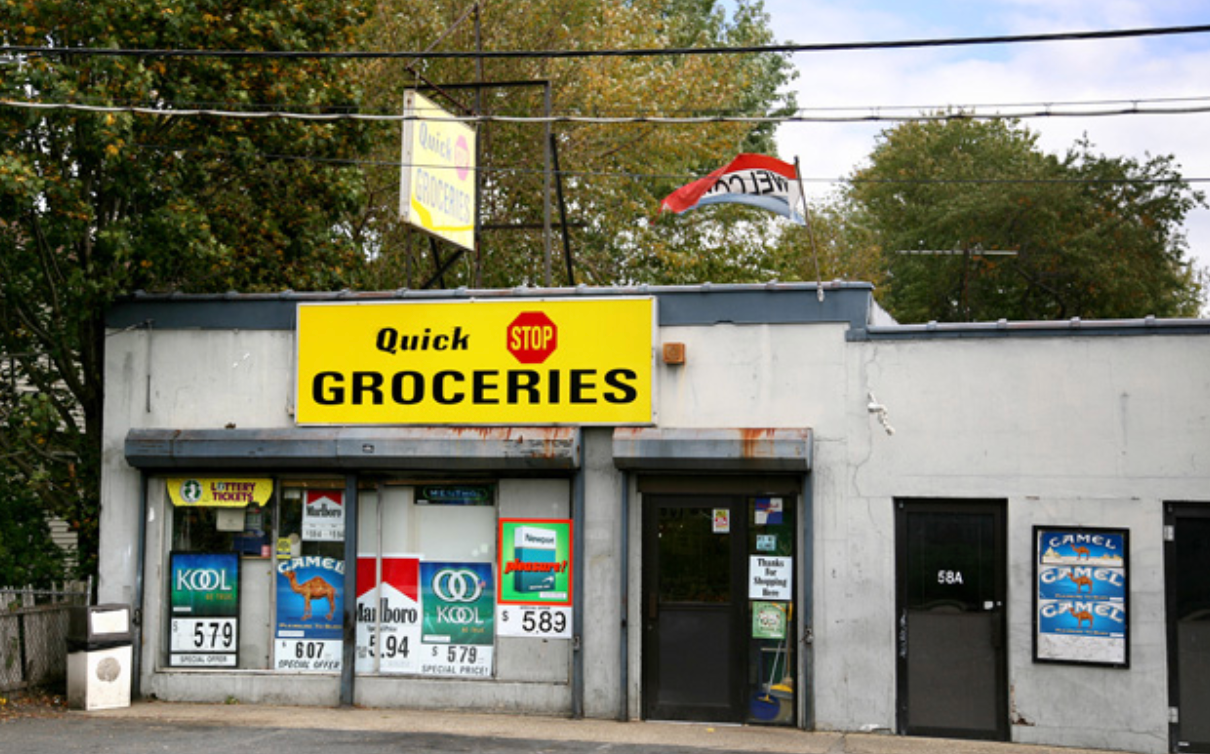 a grocery store with a bunch of signs on the front of it