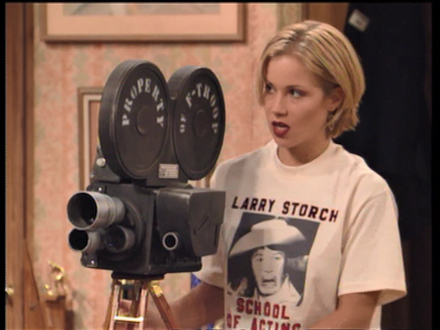 a woman standing in front of a camera