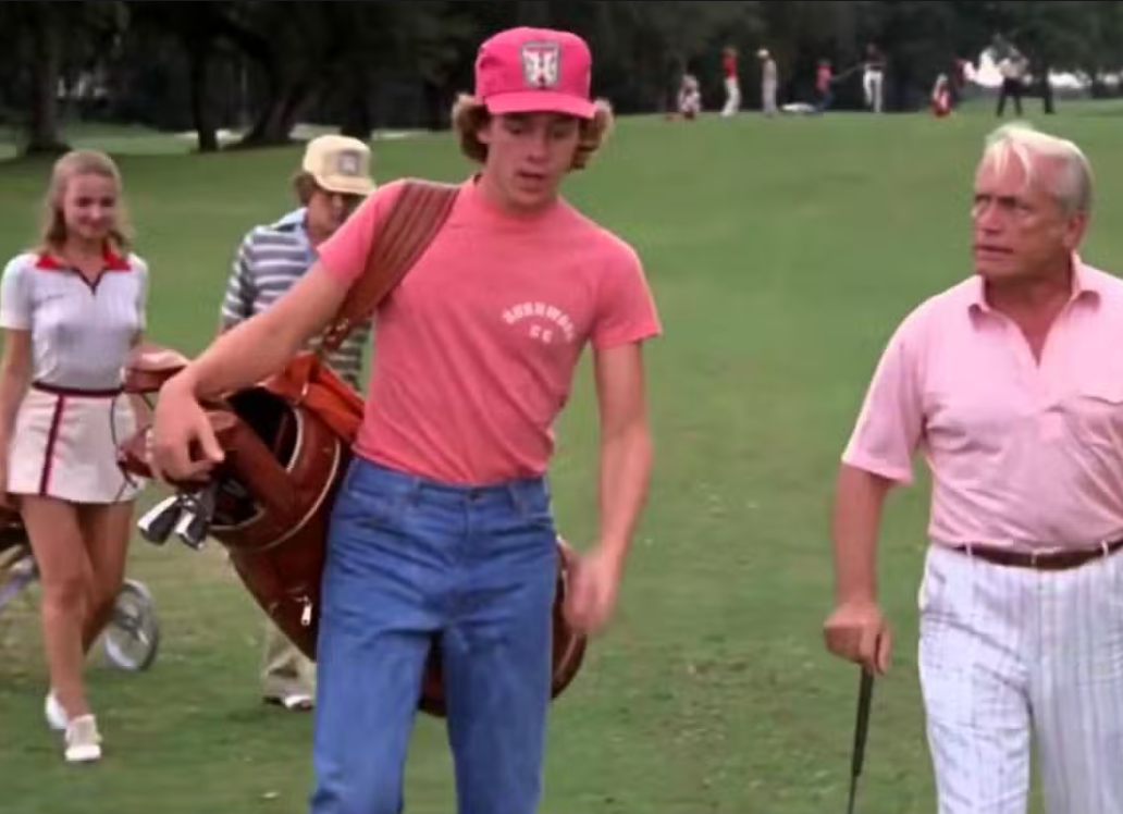 a group of people walking across a lush green field