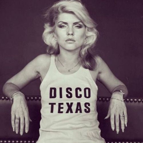 a black and white photo of a woman in a tank top