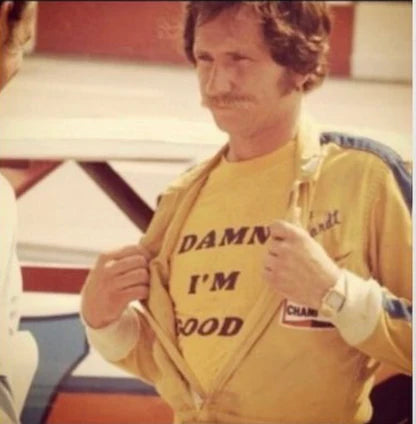 a man wearing a yellow shirt with a slogan on it