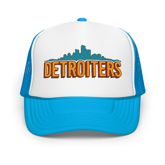A blue and white foam trucker hat for tourists that says "Detroiters" in orange with an image of the Detroit skyline in blue.