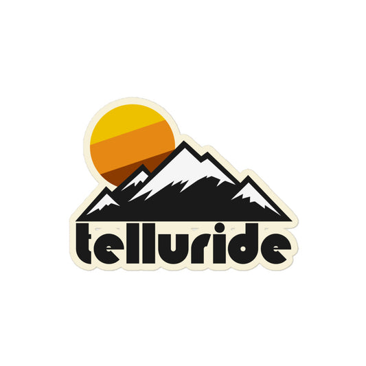 A retro "Telluride" kiss cut sticker with the image multiple mountains, their peaks snowy, and a tricolored yellow/orange/brown sun setting in the distance. References Telluride Ski Resort in the San Juan Mountains (part of the Rocky Mountains) in between two towns: Telluride and Mountain Village.