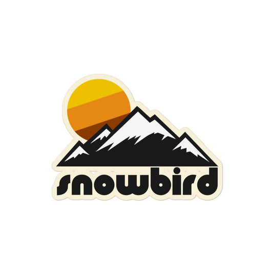 A vintage "Snowbird" kiss cut sticker with the picture of a couple mountains topped with snow and a yellow, orange, and brown sun setting. References the ski resort in Utah.