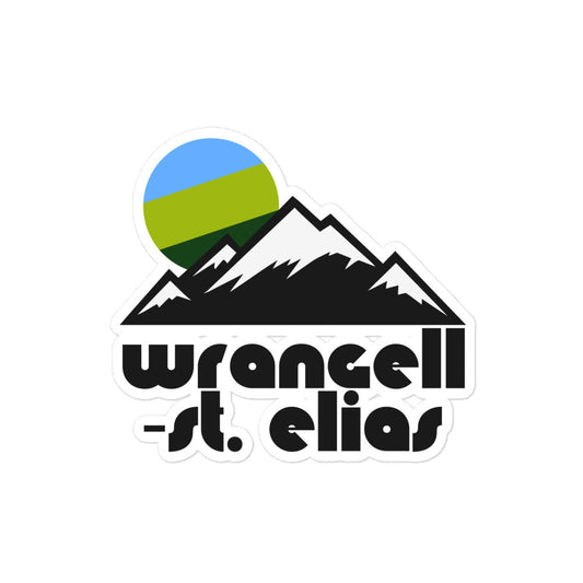 A Wrangell-St. Elias retro style kiss cut sticker with the image of snow peaked mountains and a blue, lime green, and forest green sun. Known as the largest national park and preserve in the United States, the Alaskan preserve contains volcanoes and glaciers.