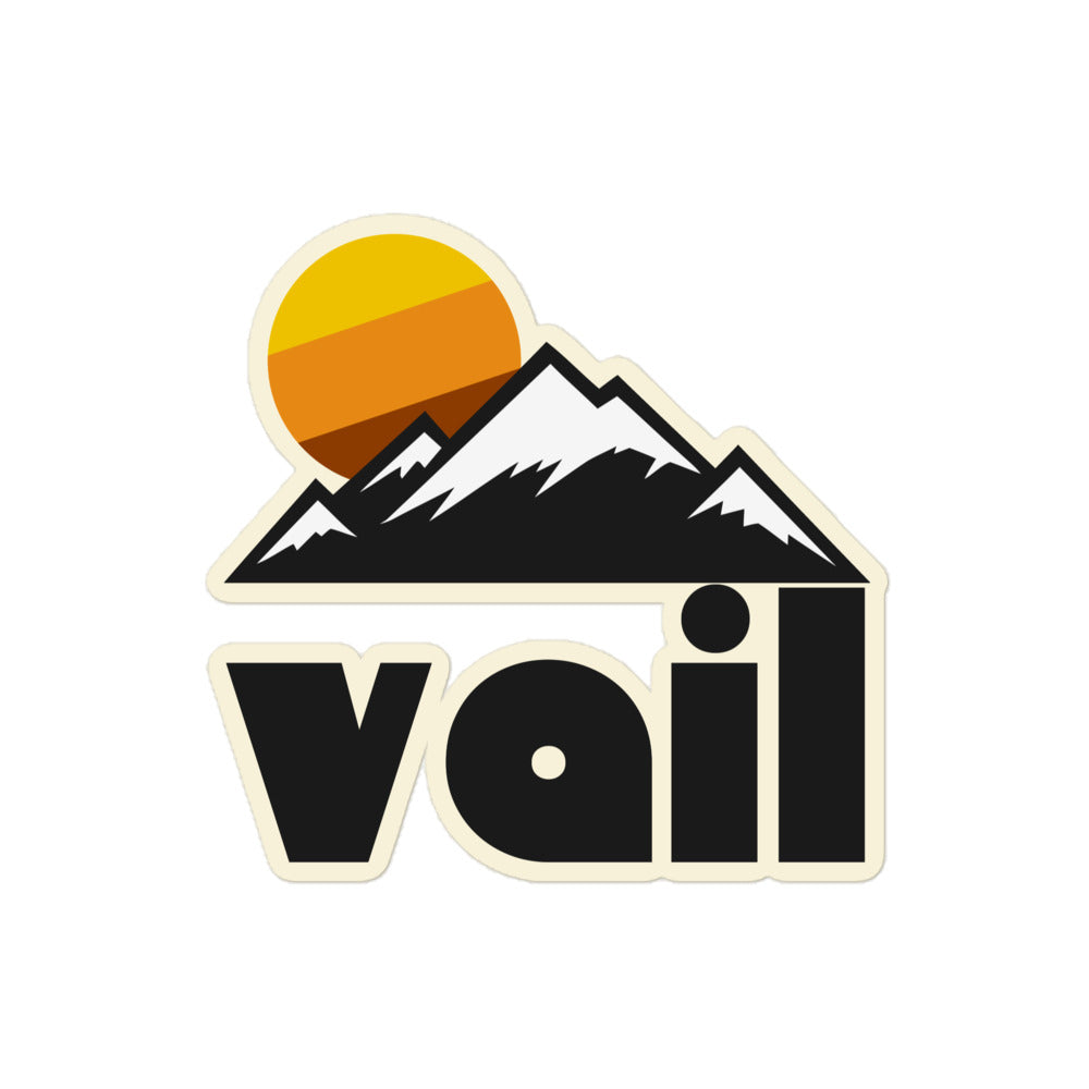 A Vail retro kiss cut sticker with an image of snowy mountain peaks and a tricolored sun setting behind in reference to the popular Colorado tourist destination, known for its ski resorts and hiking trails.