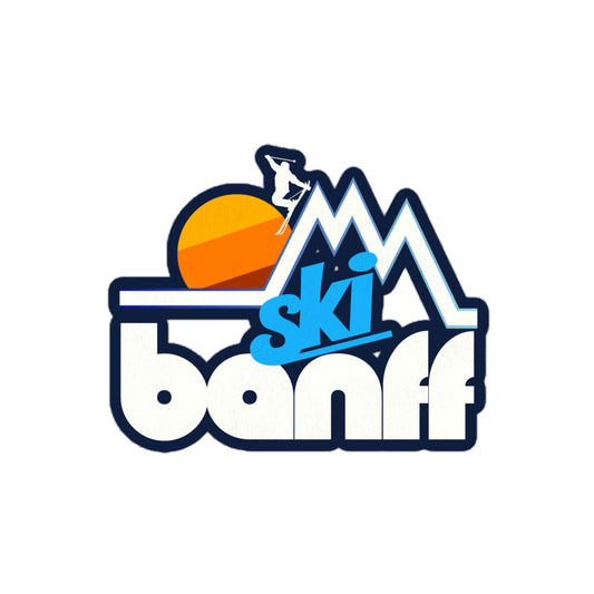 A retro "Ski Banff" kiss cut sticker with the image of a skier jumping off a mountain peak in front of a setting yellow/orange/brown sun. References Banff National Park in Alberta's Rocky Mountains.
