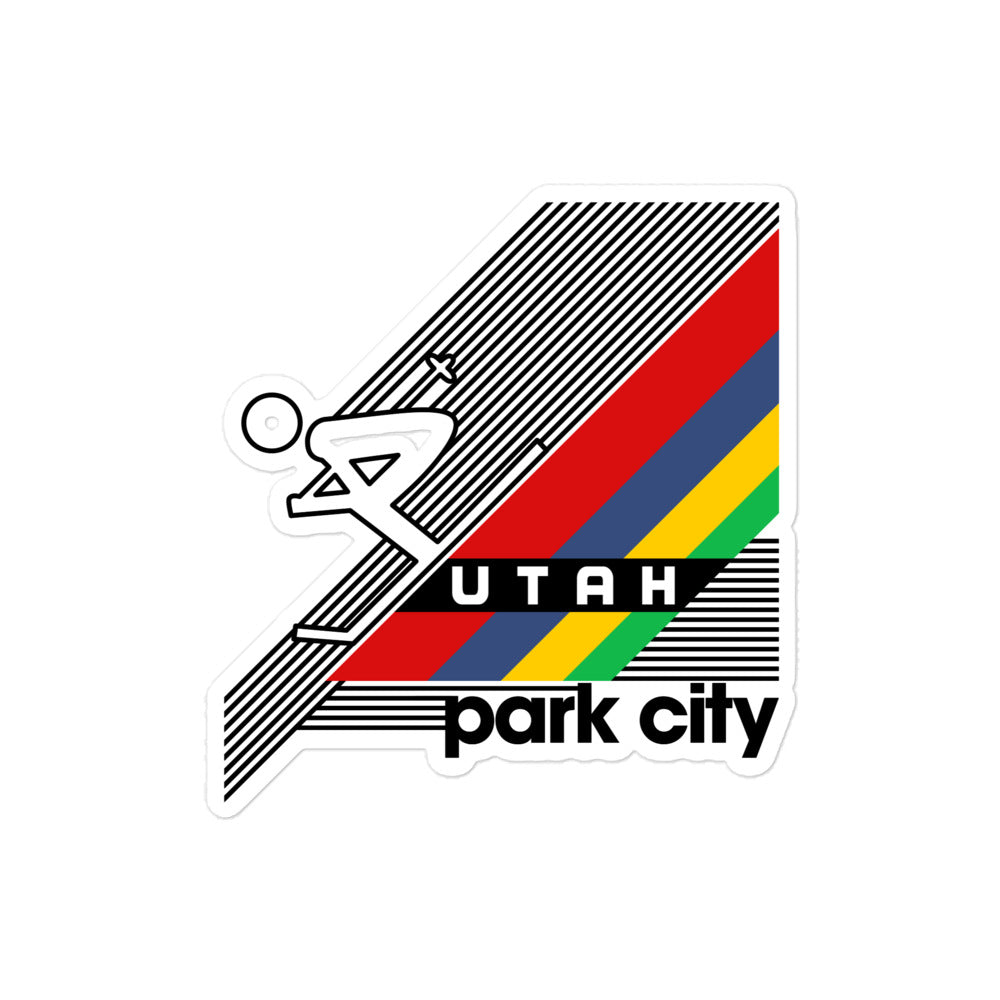 A Utah Park City retro kiss cut sticker with stripes of red, blue, yellow, and green and the image of a man skiing down a steep incline mountain.