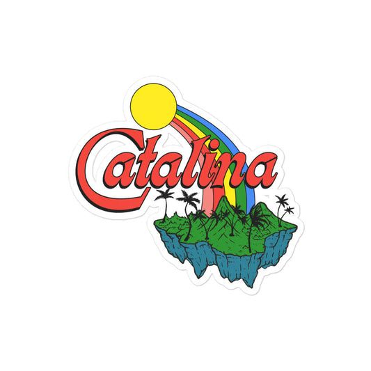A kiss cut sticker that says Catalina in red block letters, referring to Santa Catalina Island in Los Angeles County, California. Image of yellow sun and vibrant rainbow down to an island with cliffs and palm trees.