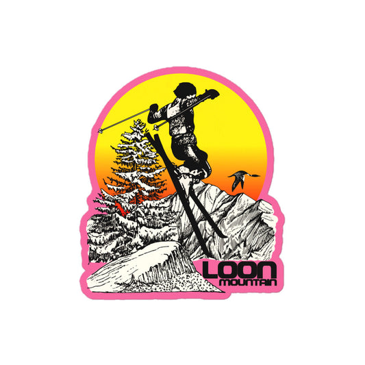 Kiss cut vintage sticker that says "Loon Mountain" with image of hombre yellow to red sun setting, snow colored aspen trees, mountain ranges, and a loon bird. A man in the center is skiing off a jump. Referencing the New Hampshire skiing and snowboarding retreat.
