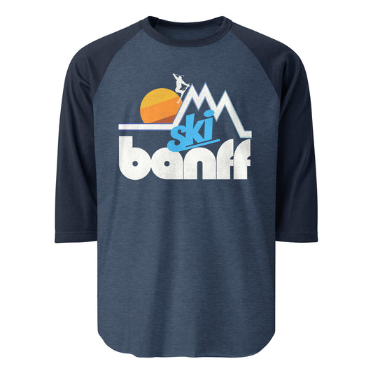 A three quarter sleeve raglan retro heather and navy blue shirt that says "Ski Banff", referencing Banff National Park in Alberta, Canada, known for its incredible hiking trails and ski resorts.