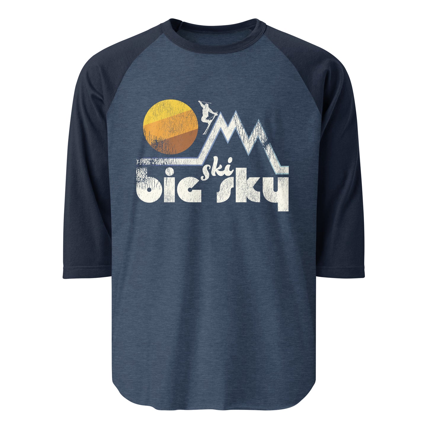 A raglan 3/4 sleeve retro heather blue and navy shirt that says Ski Big Sky with the image of a mountain range landscape and a person skiing down in a stylized pose with a large circular sun in the distance. References Big Sky Resort, popular around the US for its high snowfall and epic ski runs.