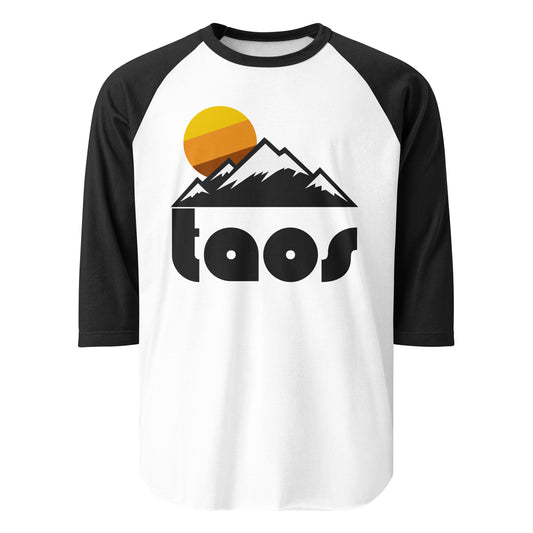A retro raglan style black and white 3/4 sleeve "Taos" shirt with an image of multiple mountains, covered in snow for skiing and snowboarding, and a yellow/orange/brown striped sun behind. References Taos Ski Valley, a world class ski and snowboard resort, located in the Sangre de Cristo Mountain Range which begins the Rocky Mountains in New Mexico. The town was originally a mining town in the 1800s.