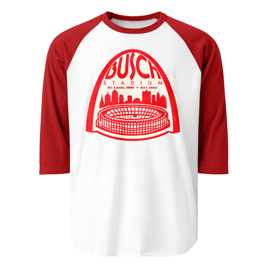 A 3/4 sleeve raglan 80s style red and white shirt with an image of The Arch over the city of St. Louis, Missouri and the famous Busch Stadium, Est. 1953 in St. Louis, MO where MLB teams the Cardinals and the Browns played.