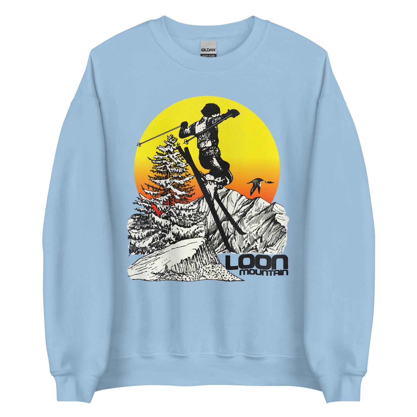 A light blue crew neck Loon Mountain sweatshirt for skiers and snowboarders. Refers to the New Hampshire ski resort on the White Mountains. Image of woman skiing, mountain peaks, fir tree, loon bird, and yellow and red hombre sun.