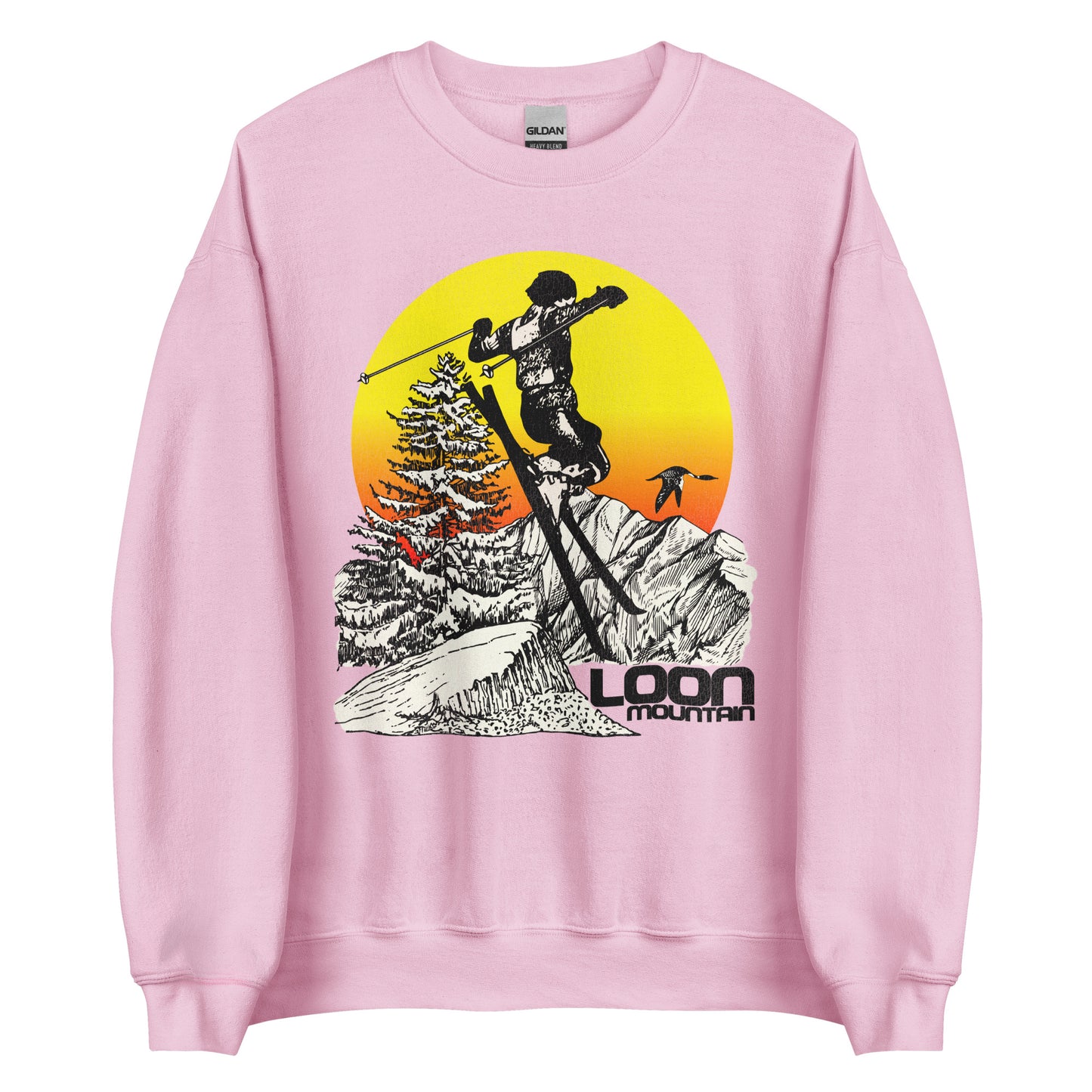 A light pink 90s style light pink crew neck sweatshirt with a yellow, orange, and red sunset and a skiier skiing past trees, the White Mountain National Forest, and a snowy hills. It says "Loon Mountain" with a loon bird flying.