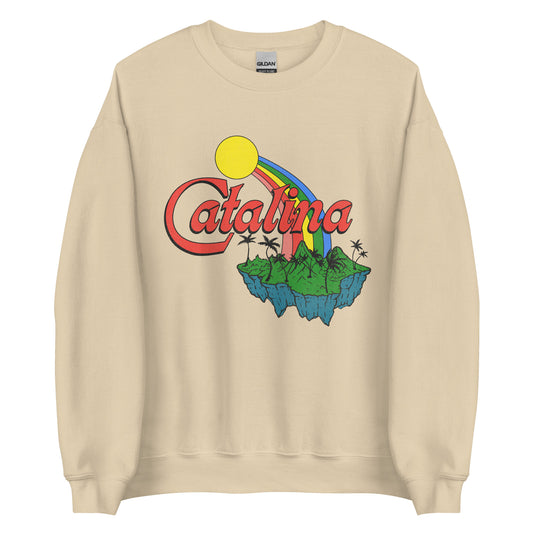 A 90s sand colored vintage crew neck sweatshirt with the word "Catalina" of the Channel Islands off the Californian cost. Image of a green, luscious, mountainous island in the Pacific Ocean with a rainbow and a yellow sun.