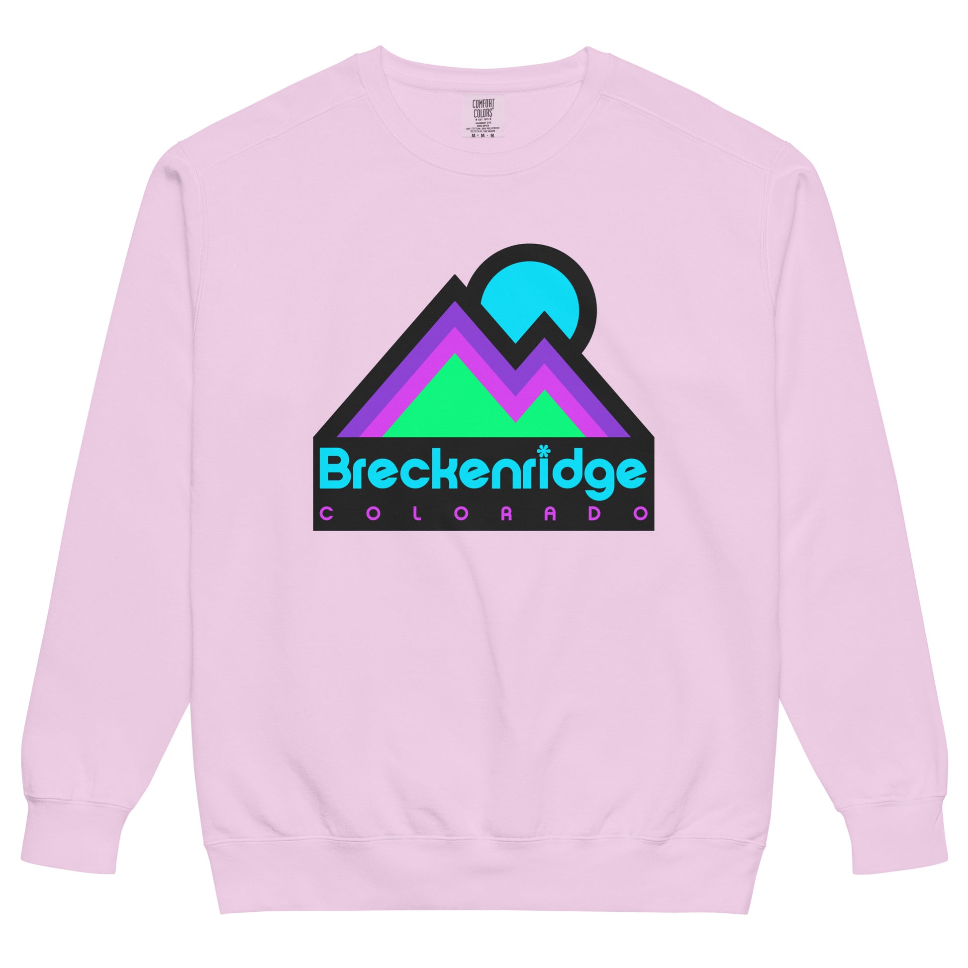 An orchid pink colored vintage Breckenridge crew neck sweatshirt with the image of a mountain range - referencing the Colorado Rocky Mountains - under a blue setting sun. Sweatshirt references the famous town and ski and snowboard resort, a popular destination for tourists, outdoor enthusiasts, and hikers.
