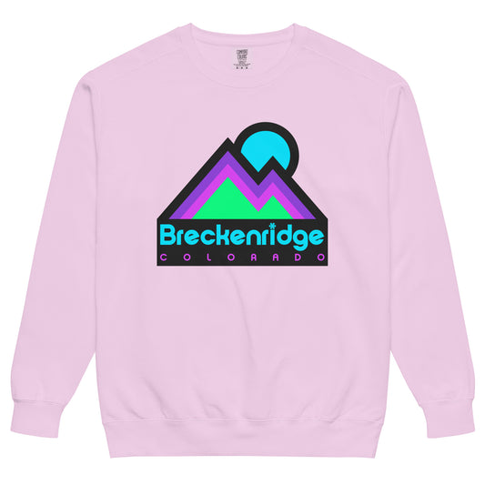 An orchid pink colored vintage Breckenridge crew neck sweatshirt with the image of a mountain range - referencing the Colorado Rocky Mountains - under a blue setting sun. Sweatshirt references the famous town and ski and snowboard resort, a popular destination for tourists, outdoor enthusiasts, and hikers.