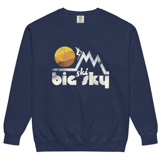 A vintage 80s style Ski Big Sky navy blue crew neck sweatshirt. Includes a skier in a mountain range with a huge sun setting. Represents Big Sky Resort in the Spanish Peaks in Montana.