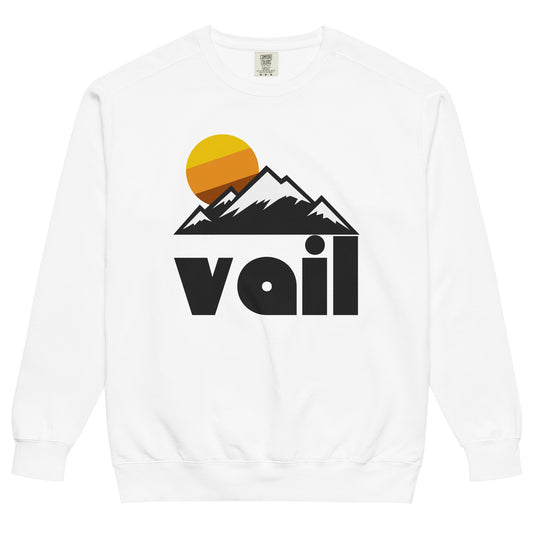 A white colored crew neck Vail souvenir 70s style sweatshirt with the image of mountains covered in snow and the sun rising above the triangular peaks. References Vail, Colorado, one of the top ski destinations in the world, located in the White River National Forest in the Gore Mountains and Sawatch Mountains.