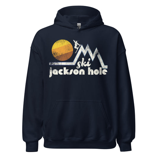 A navy blue retro 70s style "Ski Jackson Hole" hooded sweatshirt. Image of a person skiing down a tall mountain peak, doing a stylized jump, with a beautiful large sun in the distance.