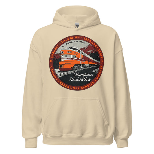 A sand colored retro hooded sweatshirt with an image of the famous "Olympian Hiawatha Speedliner Service" train which ran on "The Milwaukee Road", a network of railroads which ran from the 1840s - 1980s that connected cities that are named on the sweatshirt, including "Chicago, Milwaukee, Twin Cities, Spokane, Seattle, & Tacoma". Sweatshirt has an image of a red, orange, and white train with the label "Milwaukee Road" as it rides past mountains and forests on wooden tracks.