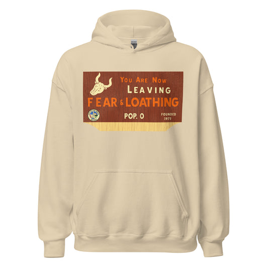 A 70s style tourist sand colored hoodie sweatshirt with the words "You are Now Leaving Fear & Loathing", "Pop. 0", and "Founded 1971". Has images including the Seal of Las Vegas (which says "City of Las Vegas, Nevada") and a horned desert animal skull. In reference to the Terry Gilliam film 'Fear and Loathing in Las Vegas', originally a novel by Hunter S. Thomas.
