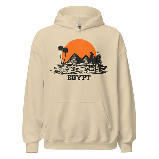 A sand colored 70s style travel hooded sweatshirt that says "Egypt" with an image of two pyramids, camels, palm trees, and dessert. References the popular tourist destination, as well as the Great Pyramid of Giza, one of the seven wonders of the ancient world and the only one still standing.