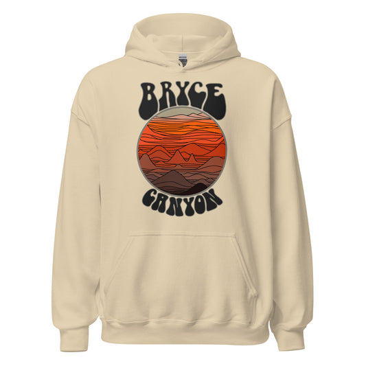 A retro sand colored Bryce Canyon hooded sweatshirt, in reference to the Utah national park, with an image of orange colored canyons, crevices, and mountains under a sky, the light resembling a setting sun.