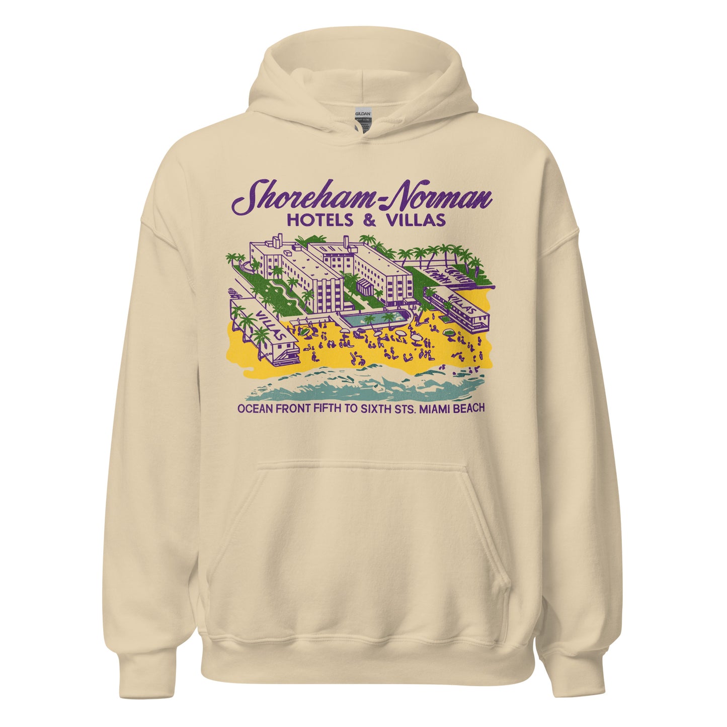 A 70s style sand colored hoodie sweatshirt that says Shoreham-Norman Hotels & Villas Ocean Front Fifth to Sixth Sts. Miami Beach. Has the image of a Florida hotel, two villas, sandy beach, ocean, tourists sunbathing, a pool, and palm trees.