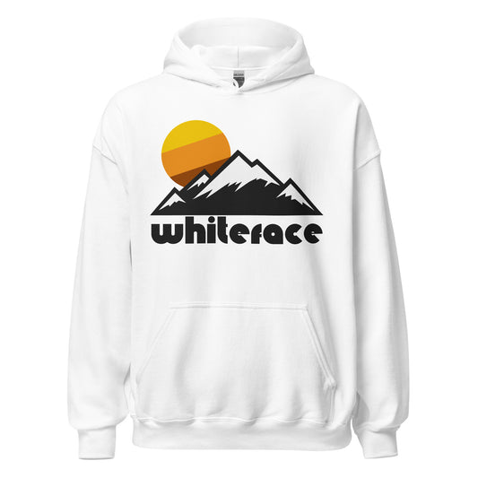 A white colored retro vintage 80s style hooded sweatshirt with the image of the Adirondack Mountains, their peaks snow covered, and a yellow, orange, and brown striped sun setting peacefully in the background. Says "Whiteface" - referencing Whiteface Mountain, located near Wilmington, New York, home to the New York Ski Resort, and known for hosting the alpine skiing competitions of the 1980s Winter Olympic Games.