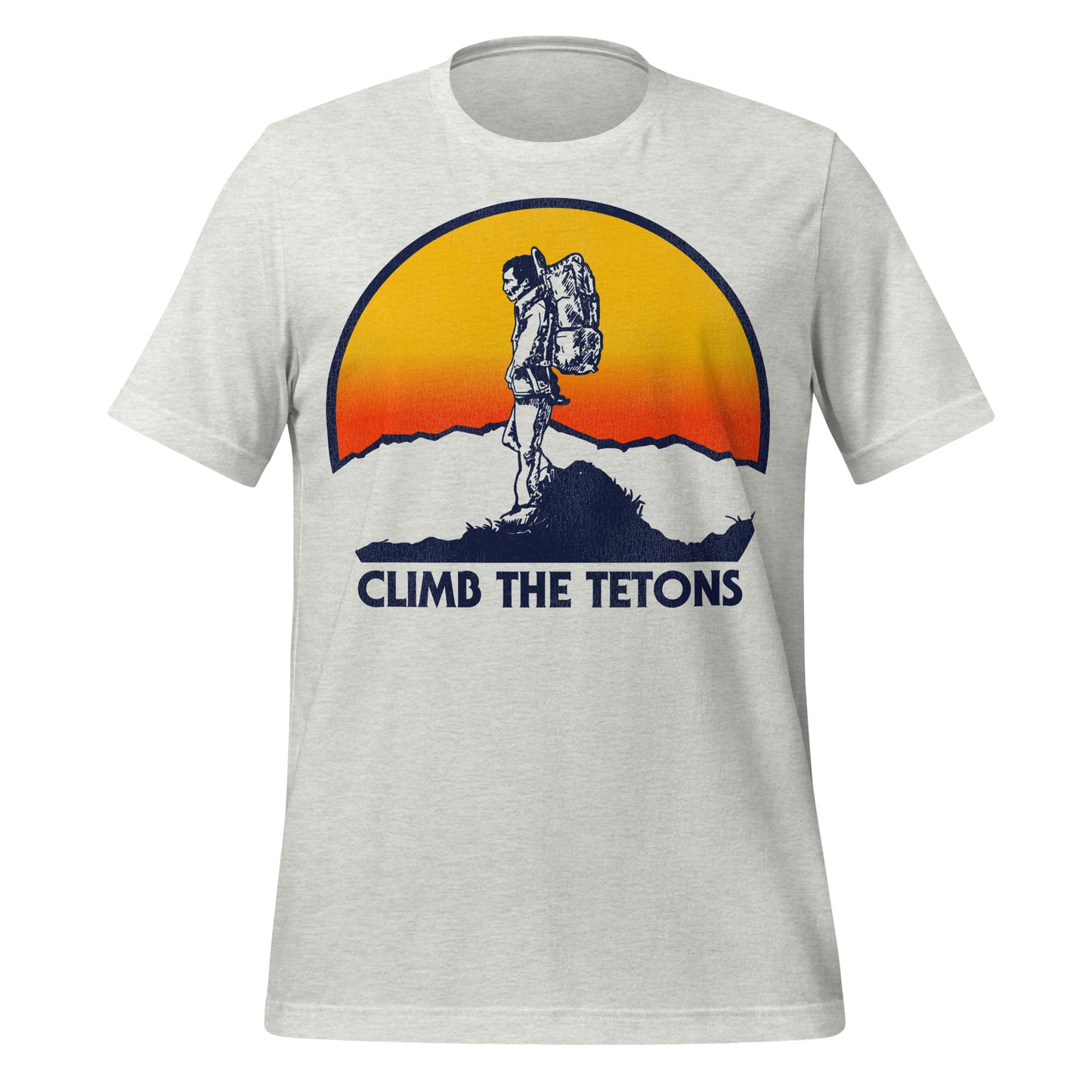 An ash gray retro 80s style t-shirt for tourists that says "Climb the Tetons" in reference to the Grand Teton National Park, named after Grand Teton which is the tallest mountain in the range, right next to Yellowstone National Park. Image of a backpacker hiking at the top of a peak wearing a jacket, carrying a backpack, taking in the scenery of a yellow and red sun and Wyoming landscape.