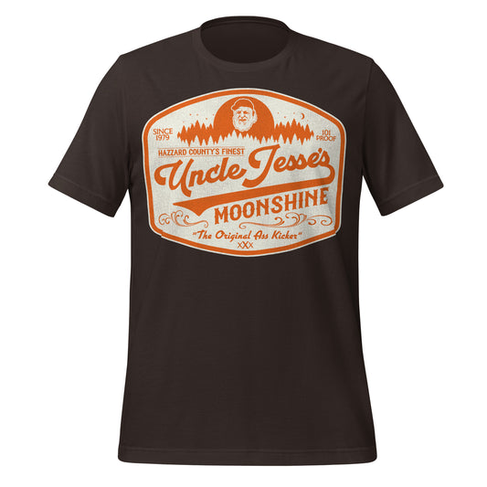 A retro 80s style short sleeve black Uncle Jesse's Moonshine t-shirt that says Hazzard County's Finest, 101 Proof, Since 1979, and "The Original Ass Kicker". Image of Jesse Duke, played by Denver Pyle, in front of an orange forest, the logo. Refers to the TV series The Dukes of Hazzard.