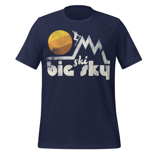 A navy blue retro Ski Big Sky t-shirt with the image of multiple mountain peaks, a skier, and a yellow/orange/brown sun. References Big Sky Resort in Montana, near Bozeman, in the Spanish Peaks.
