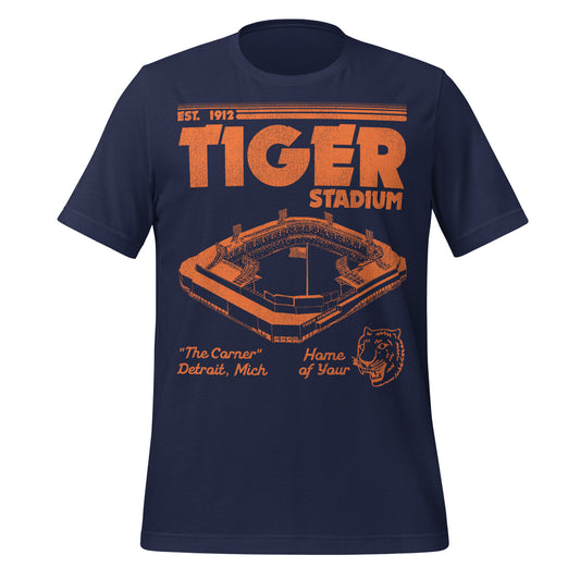 A navy and orange retro t-shirt that says "Tiger Stadium", "Est. 1912", "The Corner", and "Detroit, Mich." and "Home of Your Tigers" with an image of a Tiger in reference to the Detroit Tigers Baseball Team which played there until 2000.