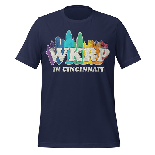 A 70s style retro WKRP in Cincinnati navy blue t-shirt with the image of the Cincinnati skyline in rainbow colors. In reference to the TV sitcom created by Hugh Wilson.