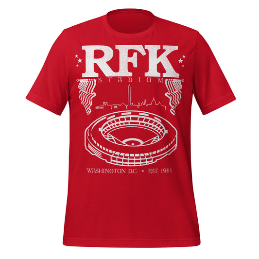 A red retro t-shirt that says "RFK Stadium" with images of American Flags, the Washington DC skyline, and an image of the circular Robert F. Kennedy Memorial Stadium which was originally called the District of Columbia Stadium. It was Est. 1961.