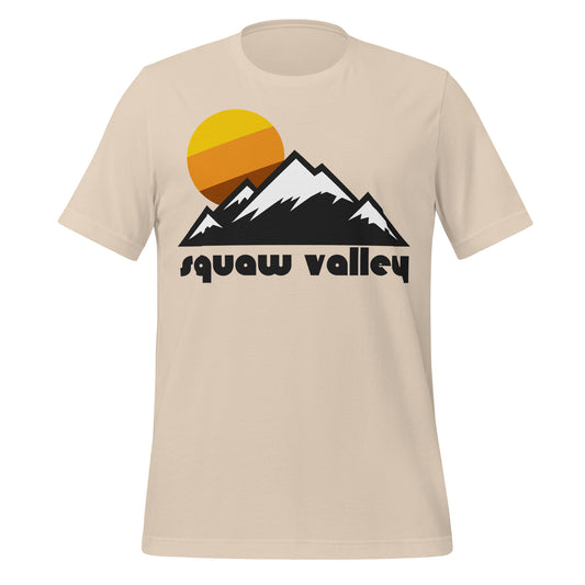 A soft cream colored "Squaw Valley" retro, 80s style t-shirt with mountain images and a sun rising behind. References the area used in the 1960s Winter Olympics now known as Palisades Tahoe on the shores of Lake Tahoe in the Sierra Nevada Mountains of California, one of the most famous skiing resort sites in the entire US.